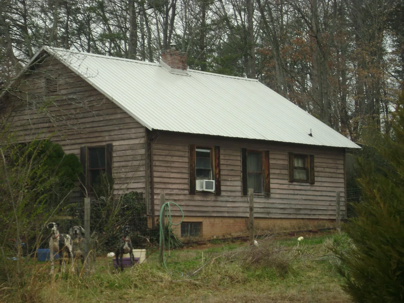 White metal roof on an old wood sided farmhouse, from a Asphalt Shingle Roof Repair job in Orange